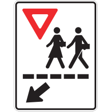 Sign with two schoolchildren walking, an arrow and a “yield” symbol. This sign indicates a school crosswalk.