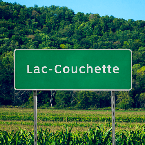 Pancarte de bord de route en campagne avec l’inscription « Lac-Couchette ».