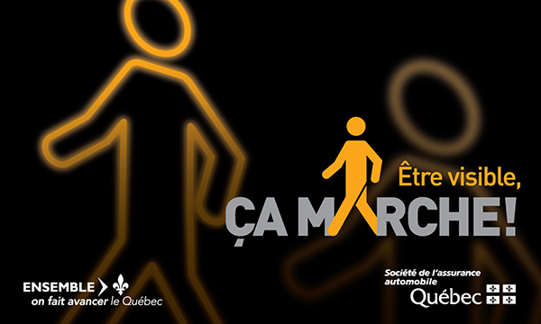 Affiche « Être visible » installée sur des palissades de construction de la ville de Montréal